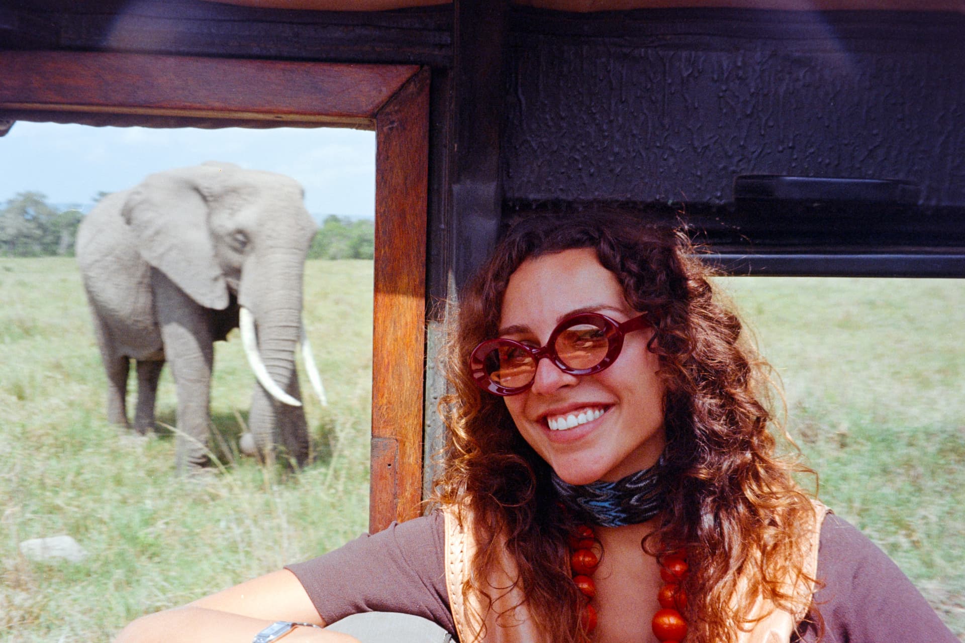 natalia on safari, an elephant behind her